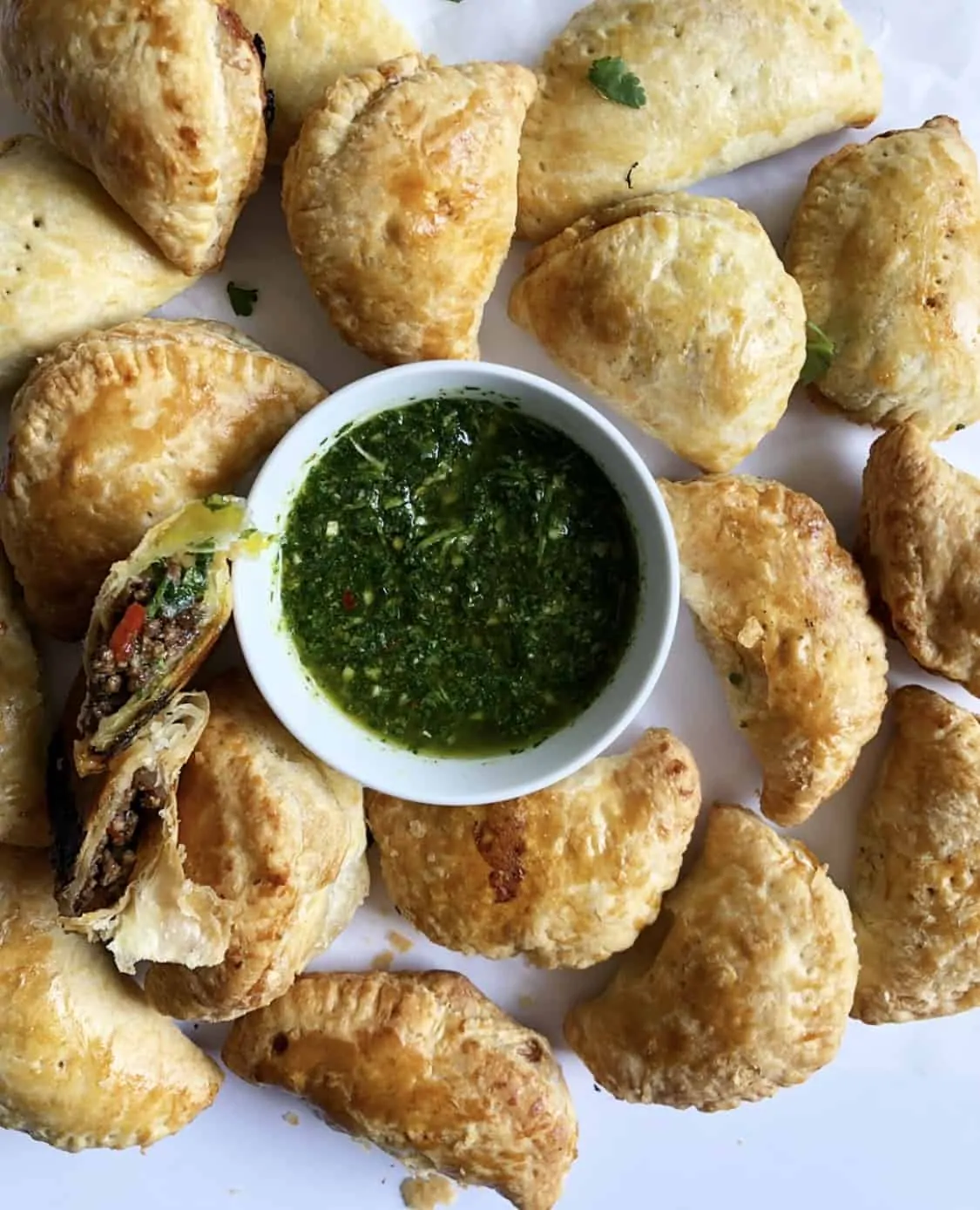 beef empanadas with chimichurri sauce in the center