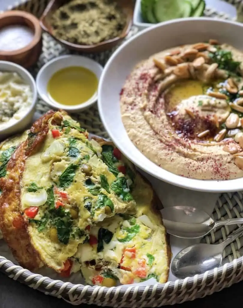 Mediterranean omelette with a bowl of hummus