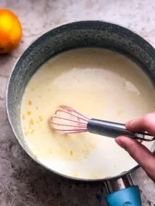 panna cotta in a pot being whisked