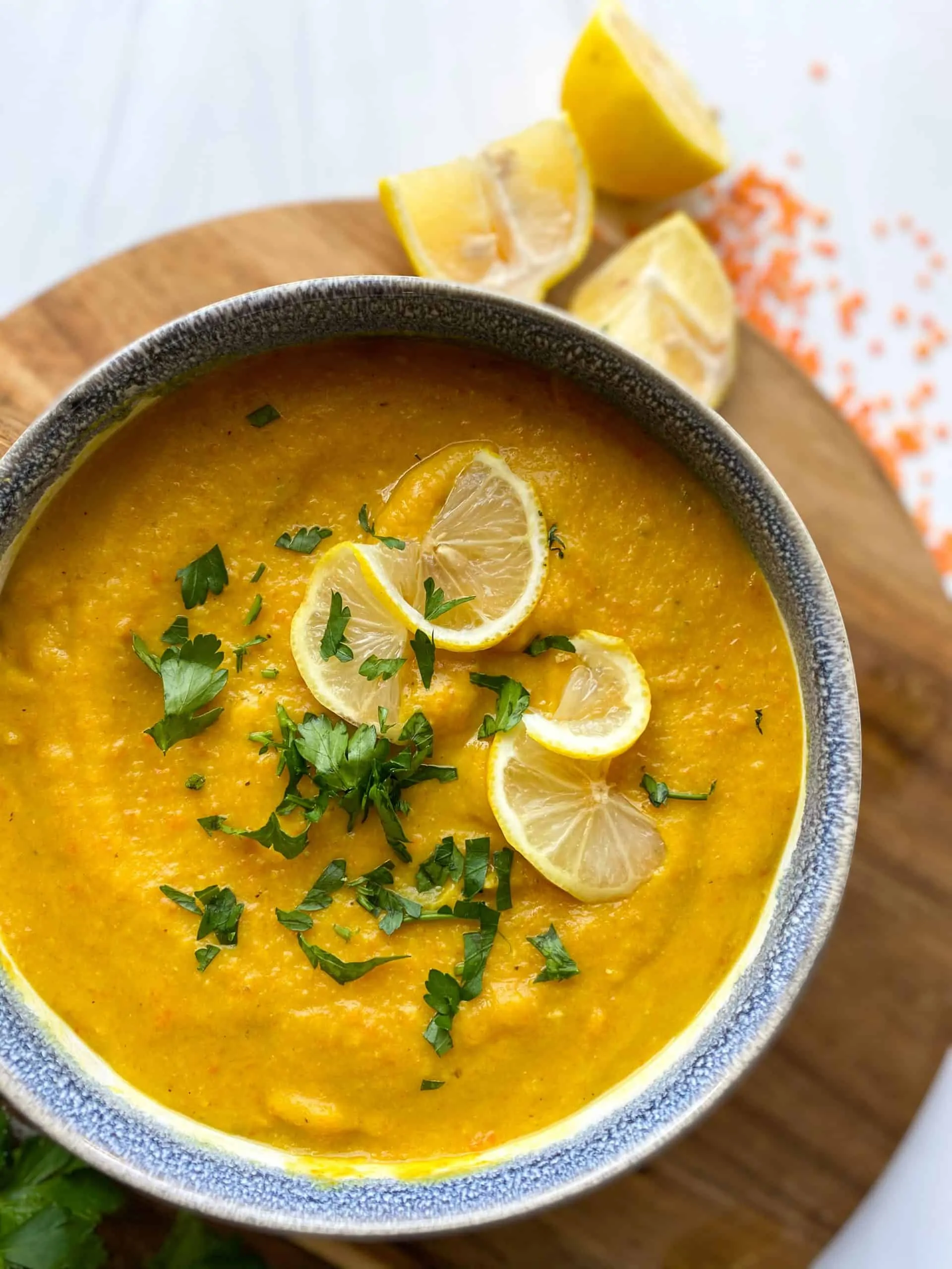 Middle Eastern Lentil Soup (shorabet adas) in a bowl topped with lemon