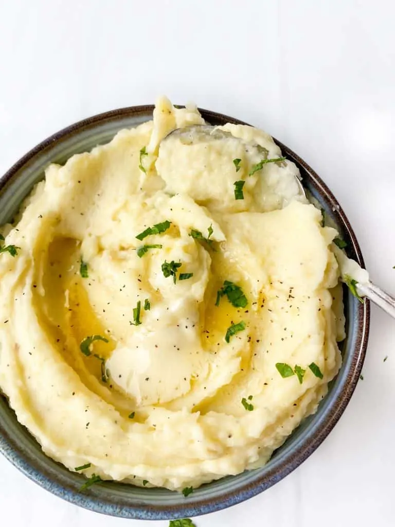 creamy mashed potatoes with black pepper flakes on top