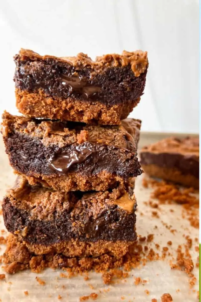 side view of biscoff brownies on a tower with the filling oozing out