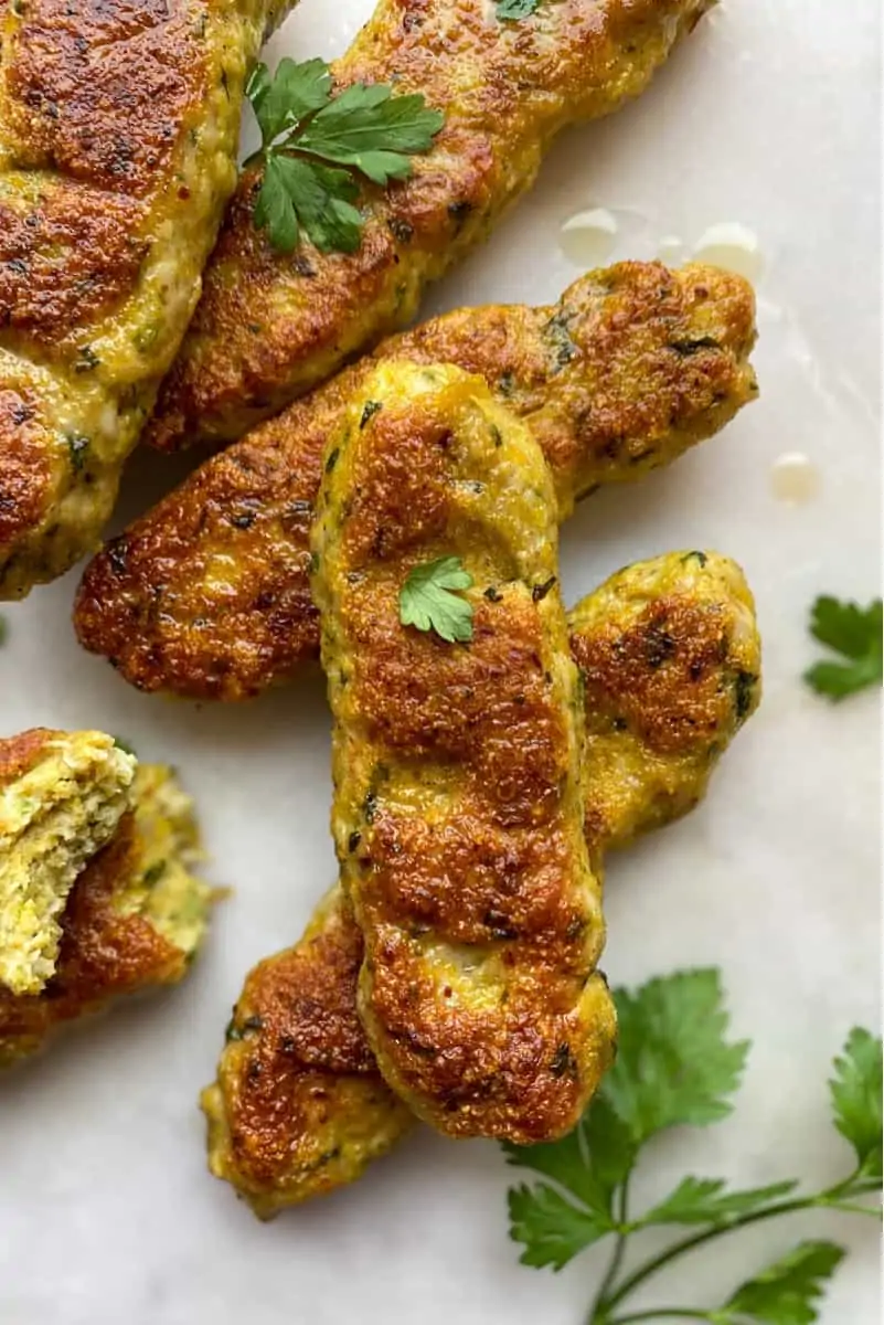 chicken kufta kebab on a plate with parsley on top