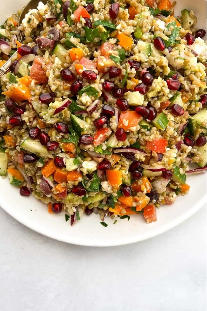 Mediterranean Freekeh Salad with pomegranates, tomatoes, and onions