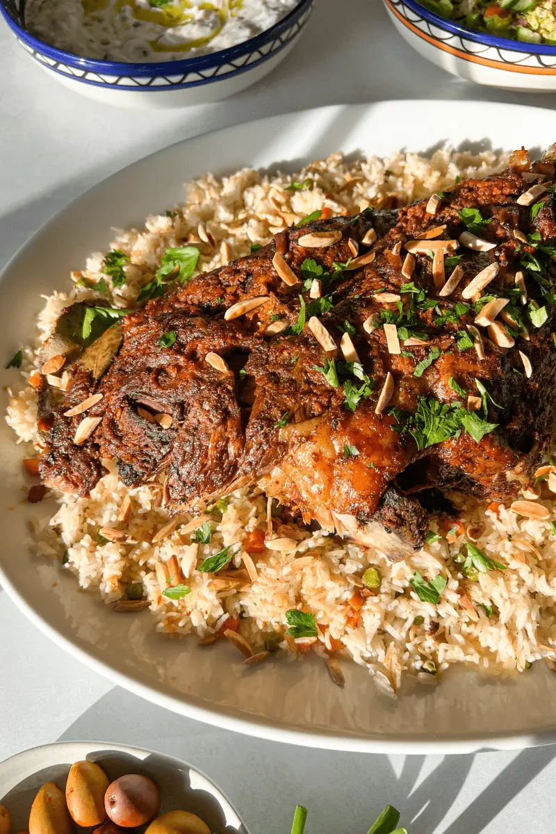 side view of roasted leg of lamb on bed of rice