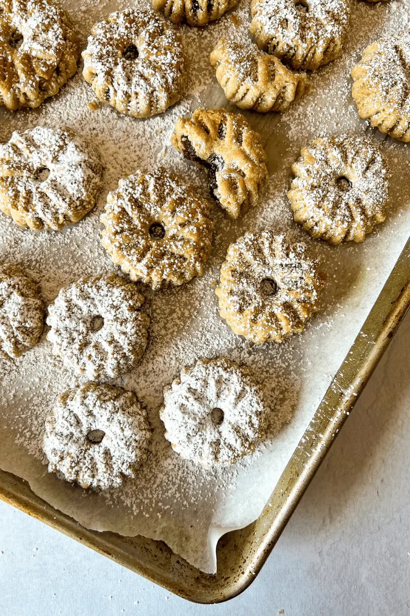 shortbread date stuffed cookies topped with powdered sugar