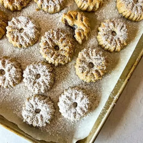 shortbread date stuffed cookies topped with powdered sugar