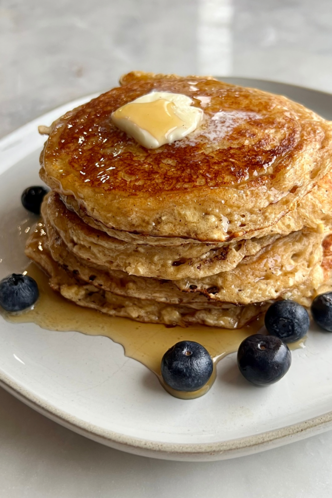 blender cottage cheese pancakes stacked with blueberries and butter
