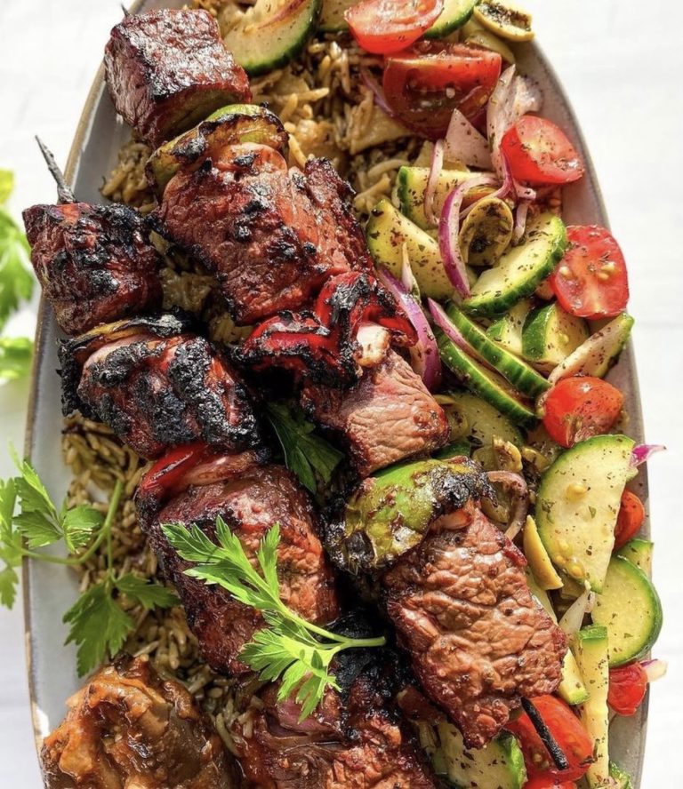 grilled middle eastern lamb skewers served on pita with charred onions and peppers