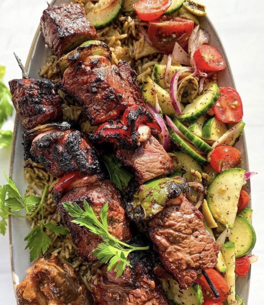 grilled middle eastern lamb skewers served on pita with charred onions and peppers