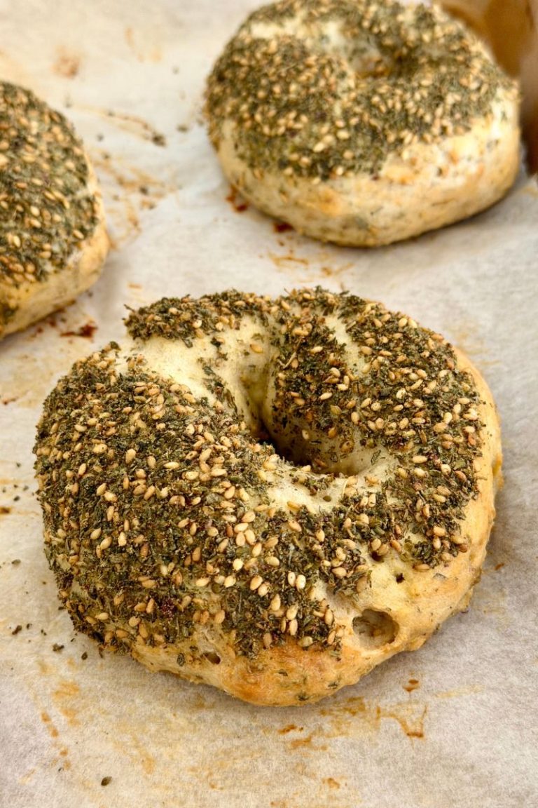 Freshly baked high-protein za'atar bagels on a parchment-lined tray
